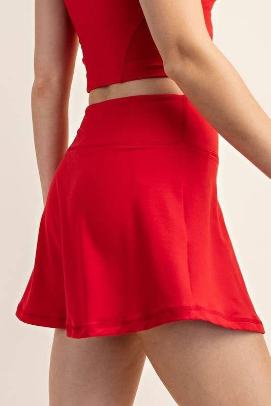 Red skirt worn by a person on a beige background